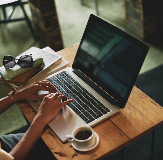 unrecognizable-asian-woman-sitting-cafe-working-laptop.png